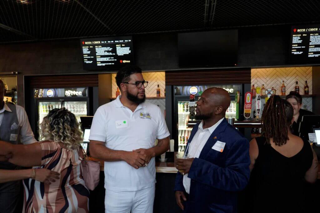 Guests mingling at a Spedidit Enterprise event in a lounge